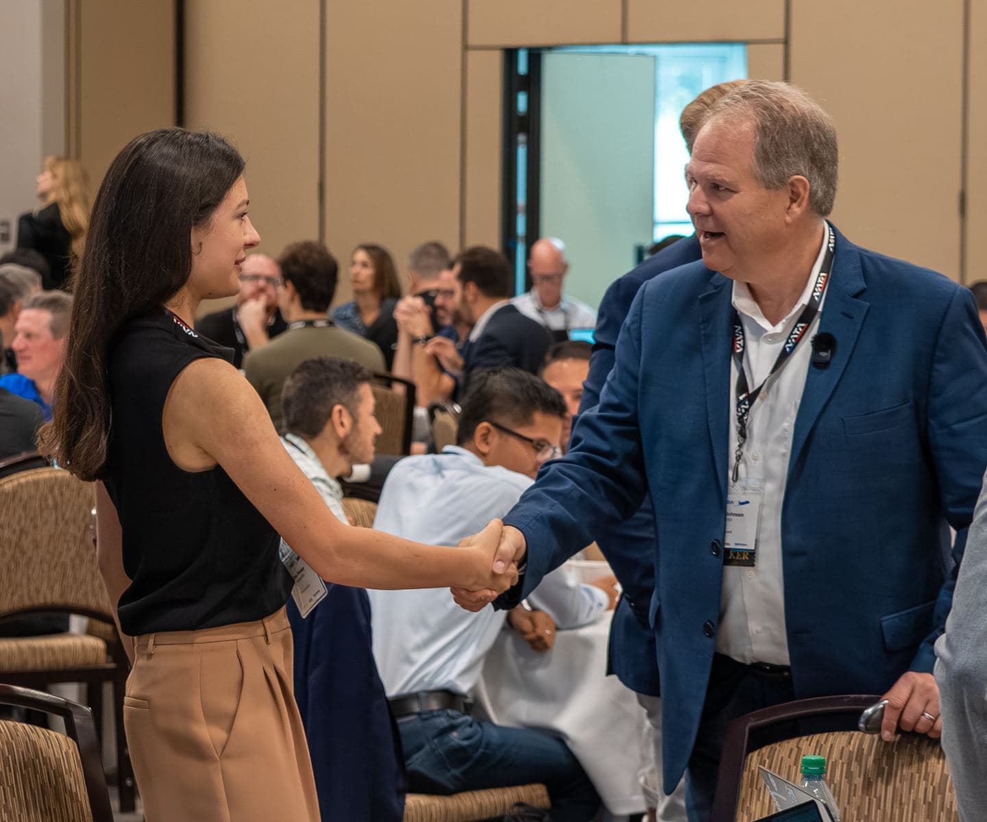 Greg Johnson greeting an attendee at the AI Symposium for Business Aviation